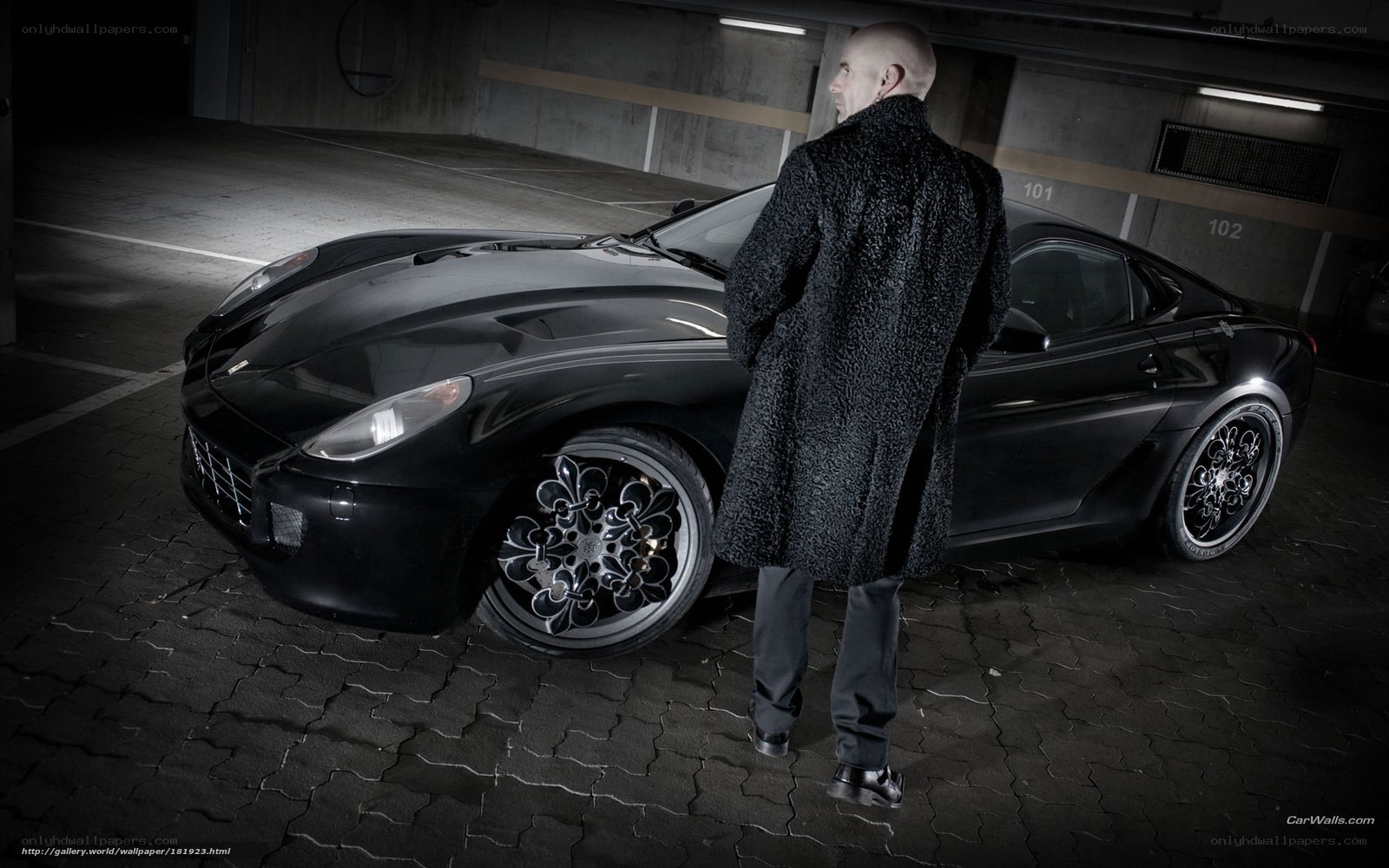 man with black car in garage