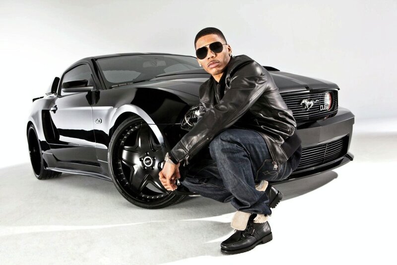 Man with black Ford Mustang