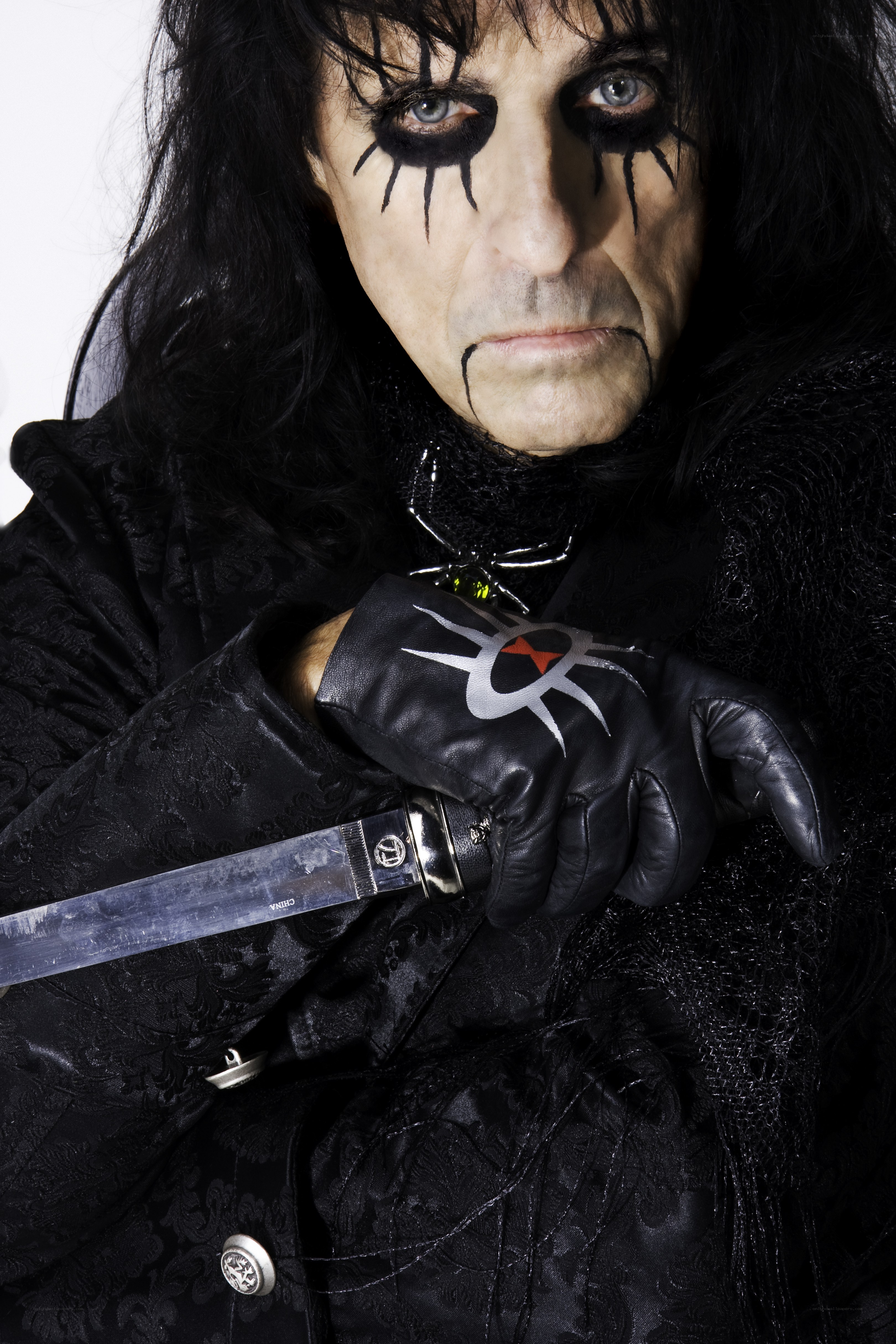 Man with black makeup and knife