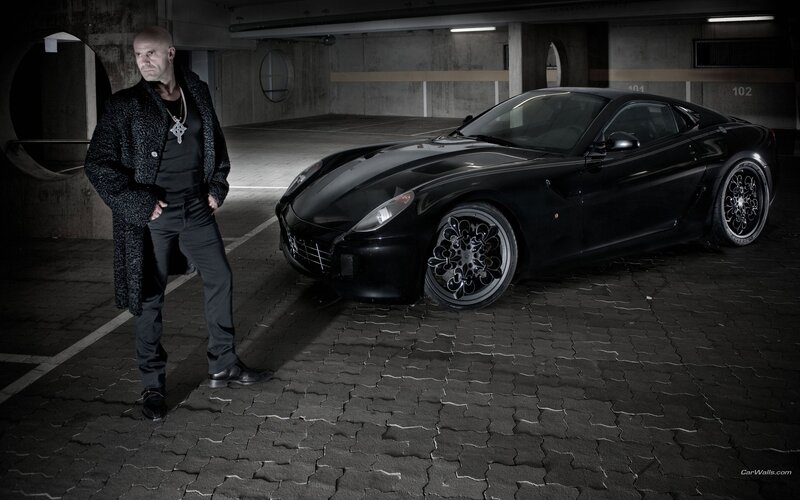 Man with black sports car