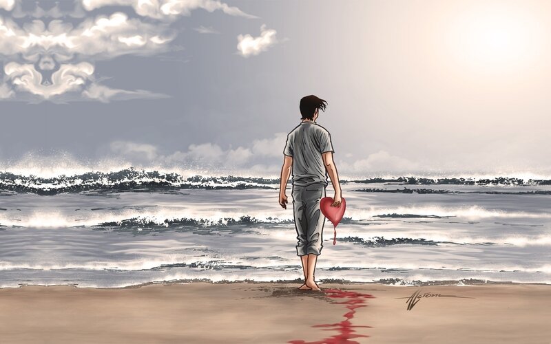 Man with bleeding heart on beach