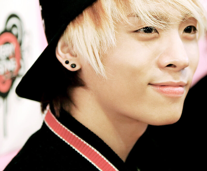 man with blonde hair and black hat