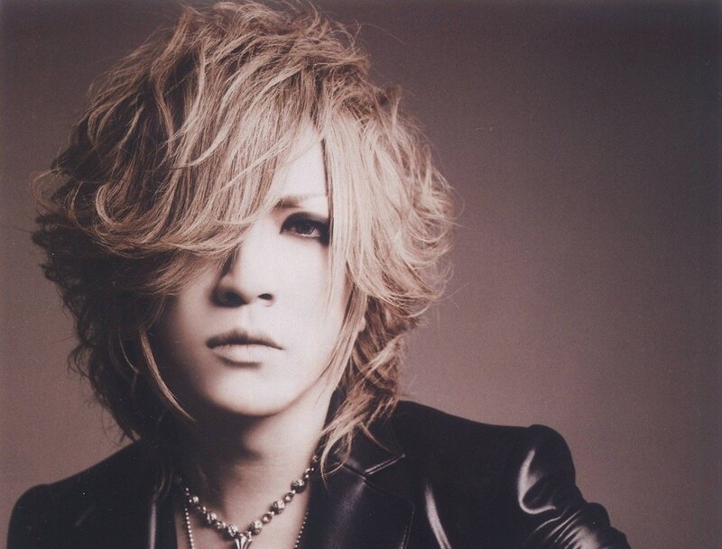 man with blonde hair in black jacket