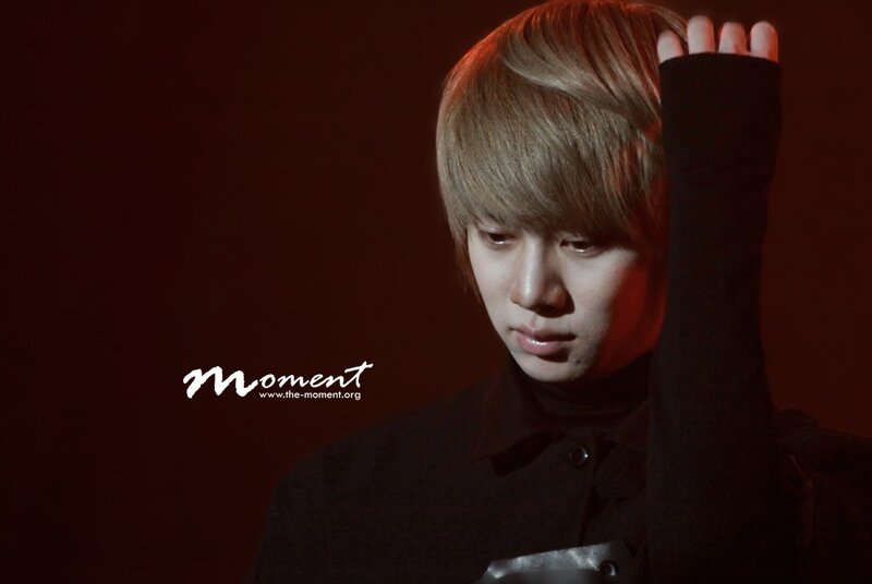 man with blonde hair in dark room