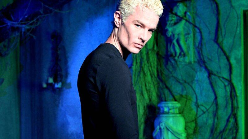 man with blonde hair in dark room