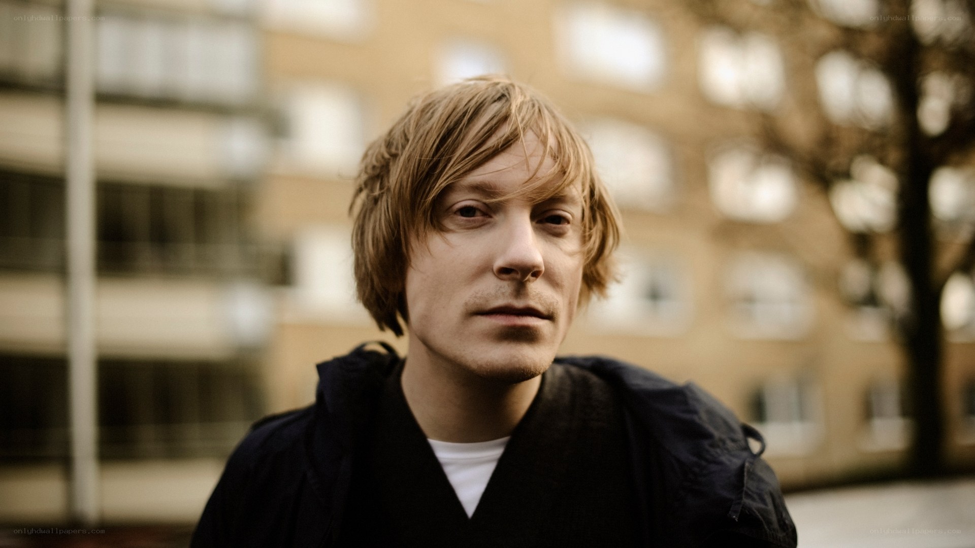 man with blonde hair in urban setting