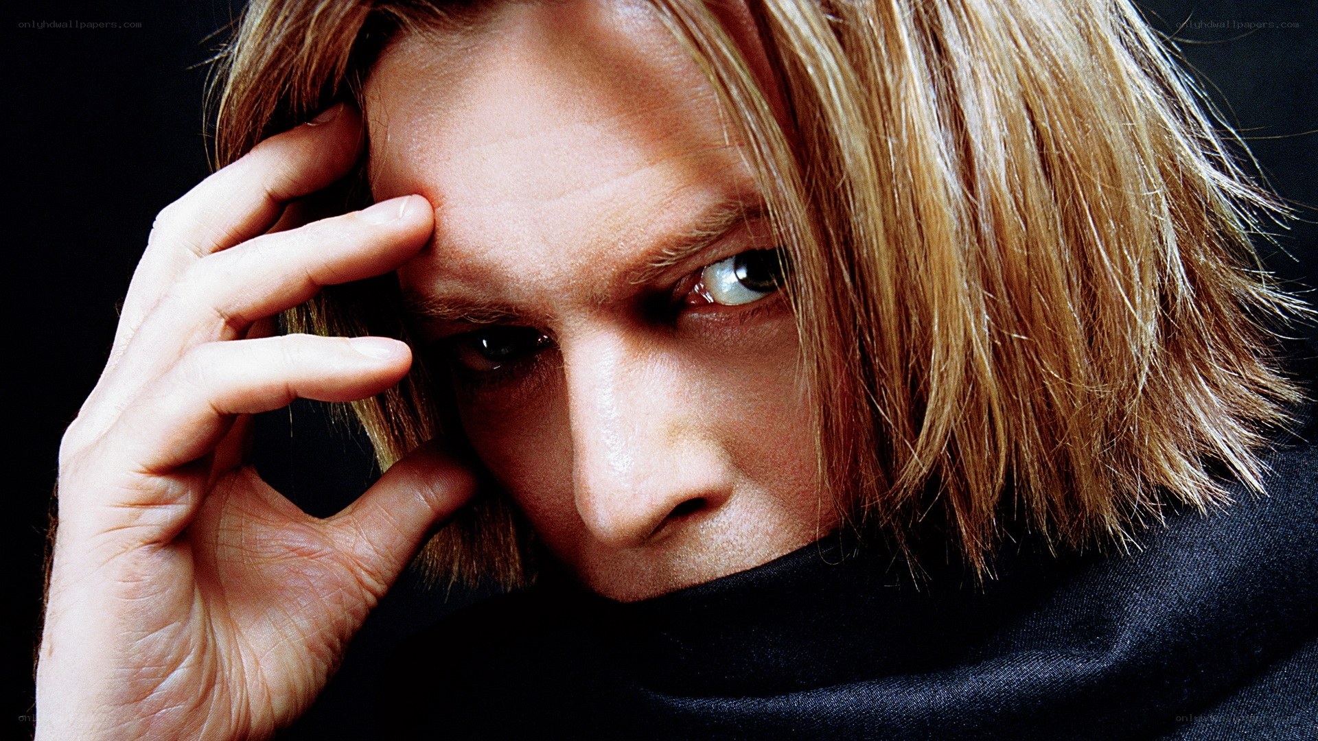 man with blonde hair looking at camera