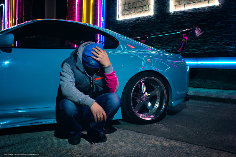 man with blue car at night
