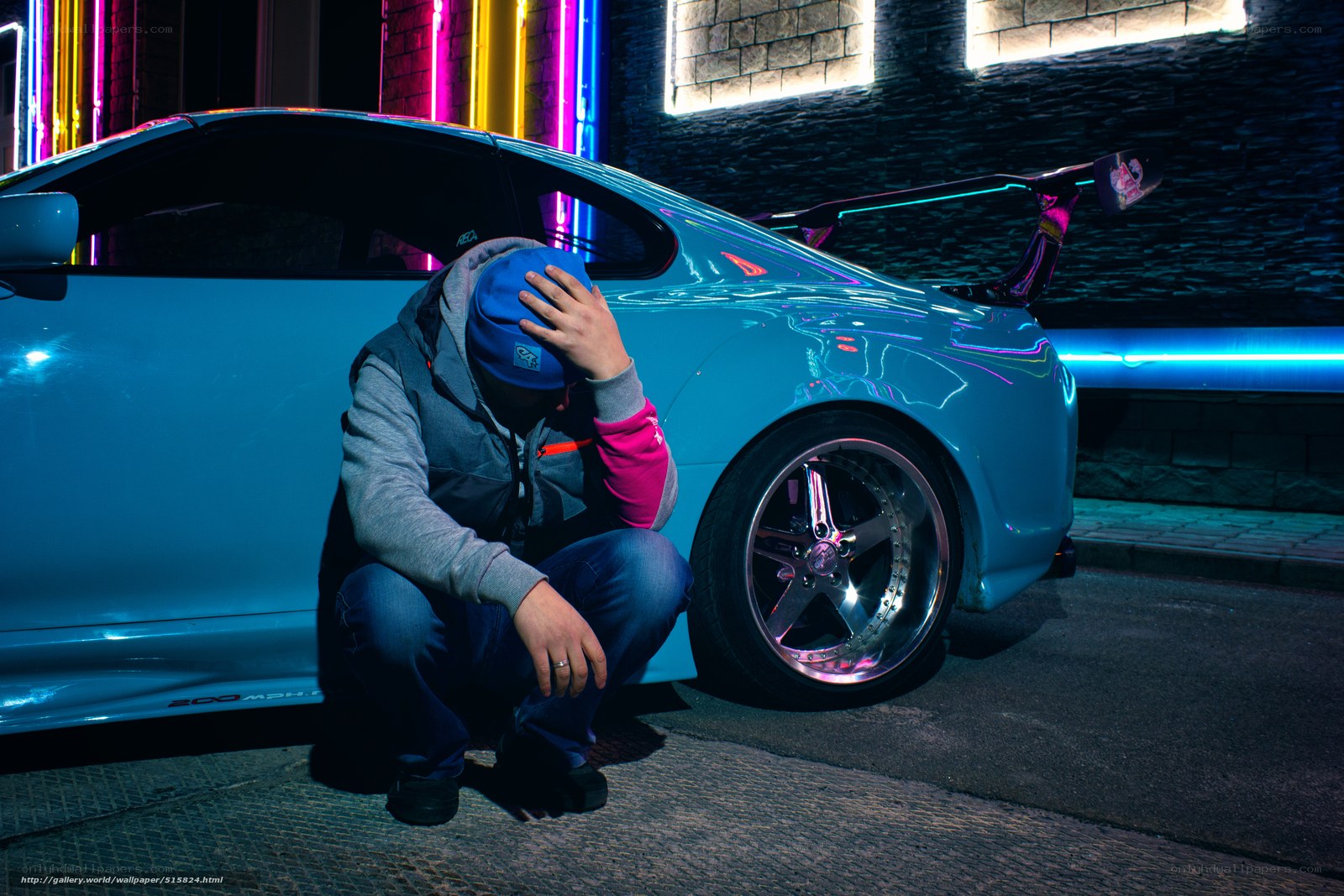 man with blue car at night