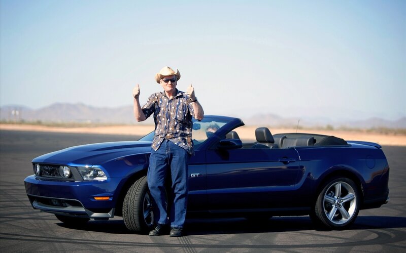 Man with blue convertible car
