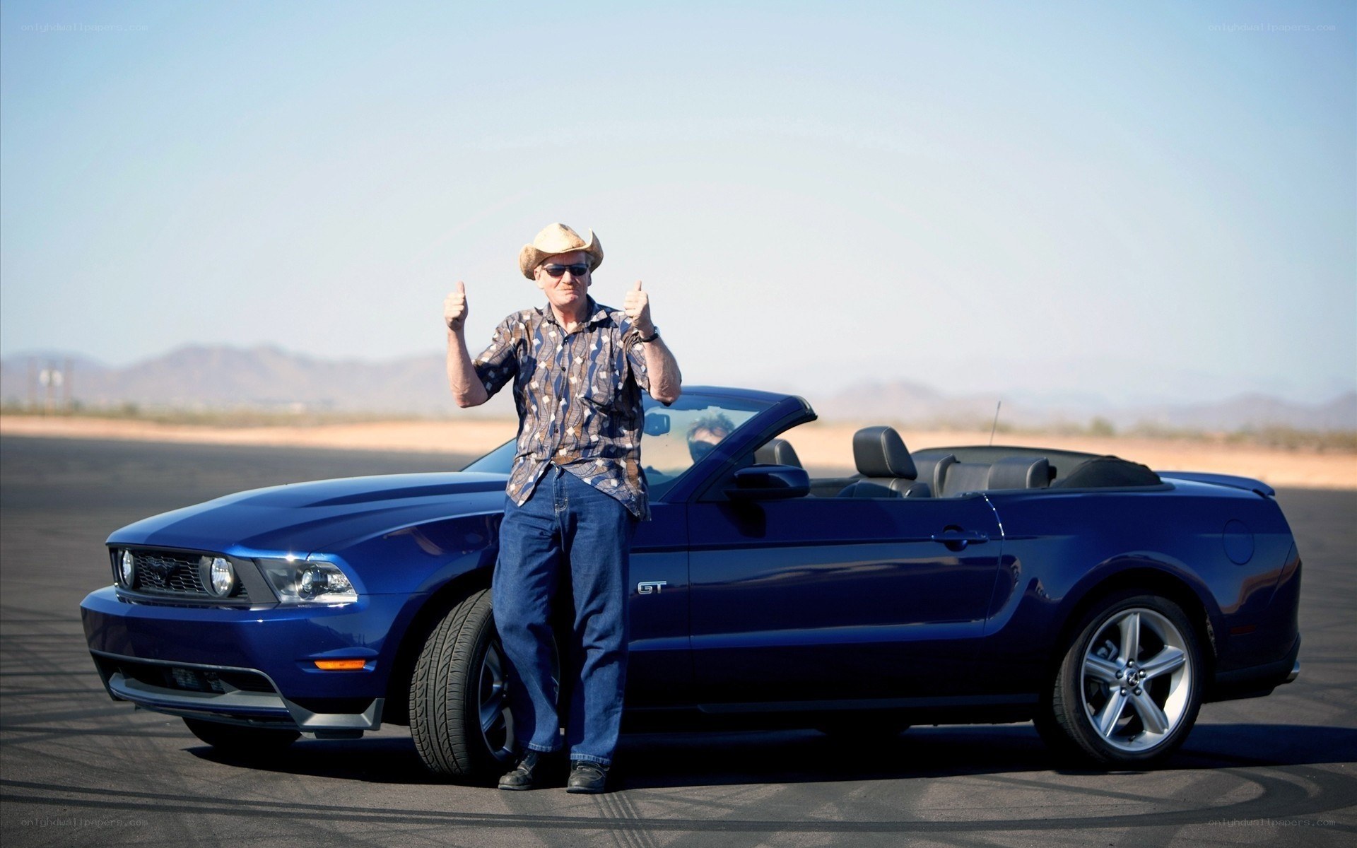 Man with blue convertible car