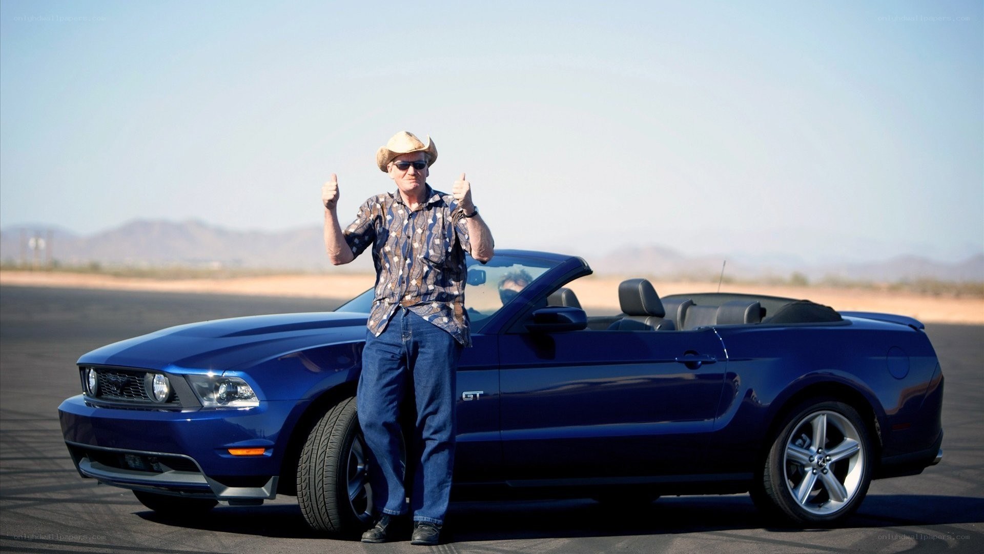 Man with blue convertible car
