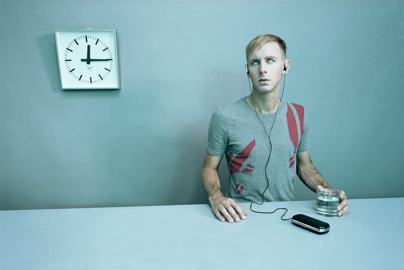 man with blue eyes and earbuds