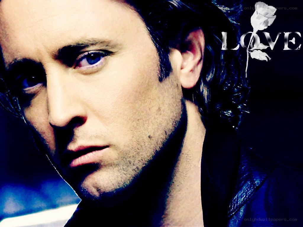 man with blue eyes and rose