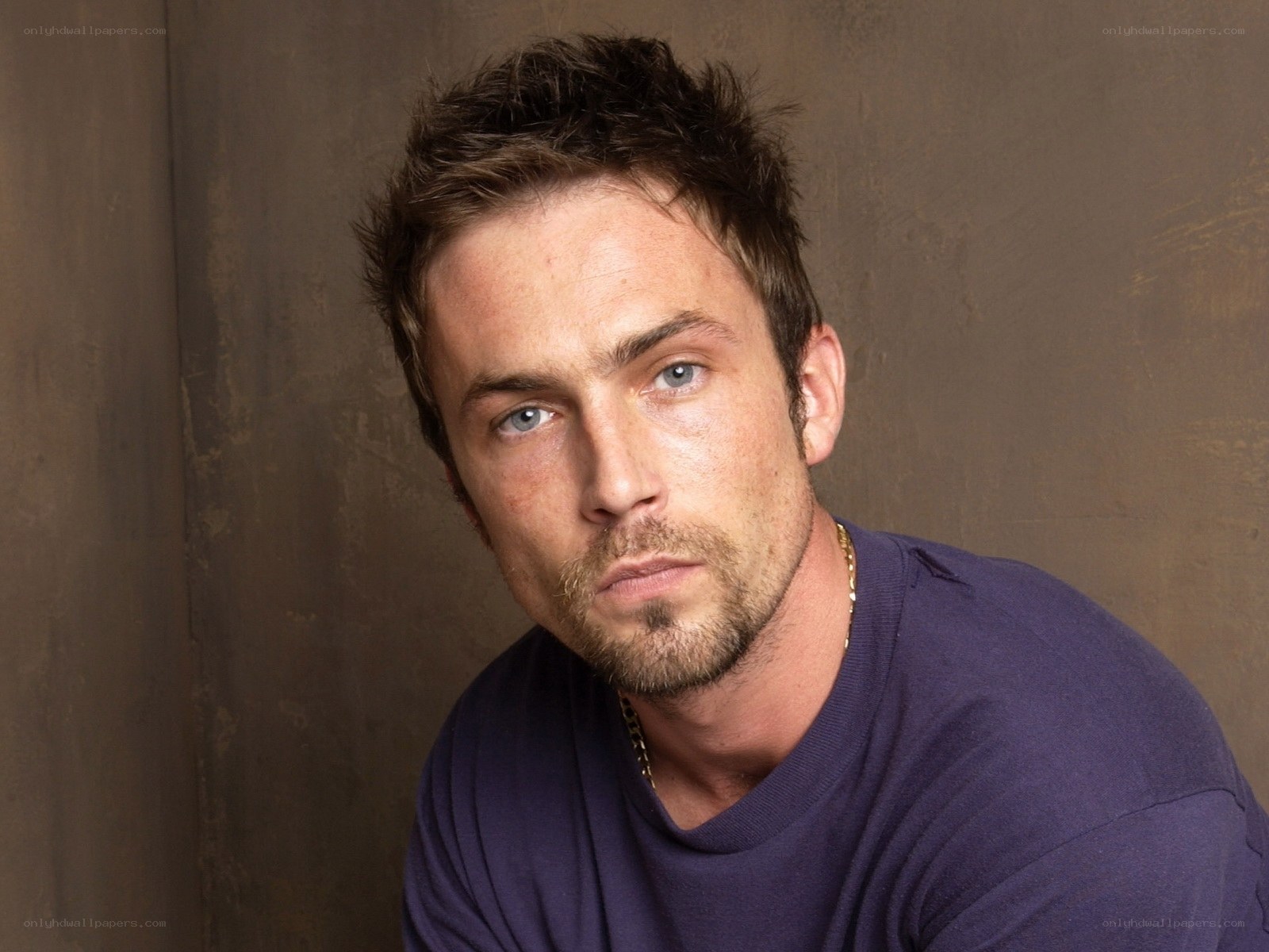 man with blue eyes and stubble