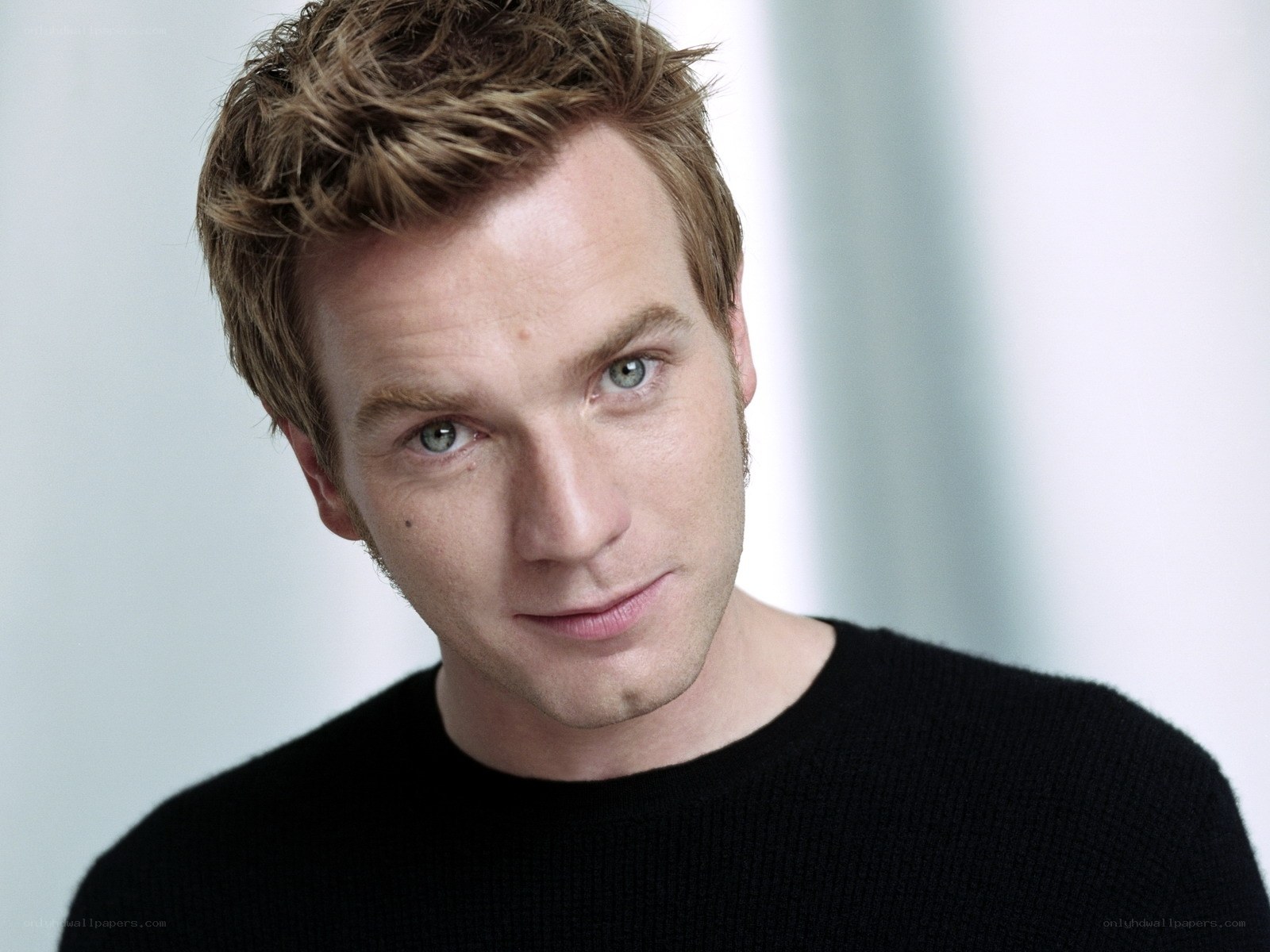man with blue eyes in black sweater