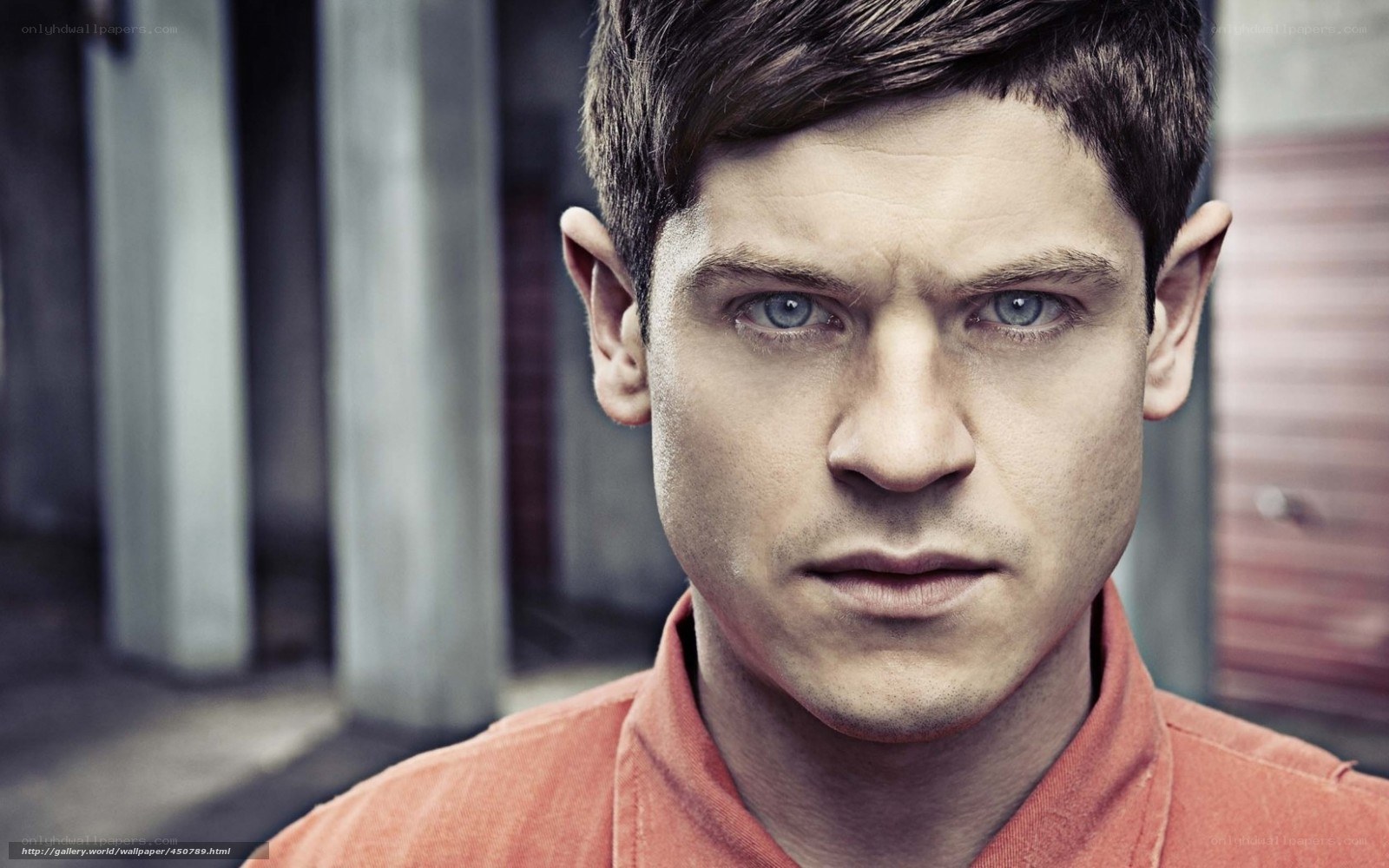 man with blue eyes in orange shirt