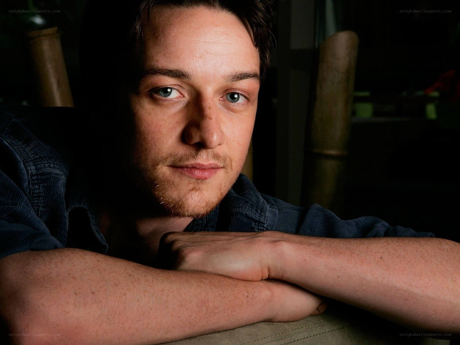 man with blue eyes resting arms