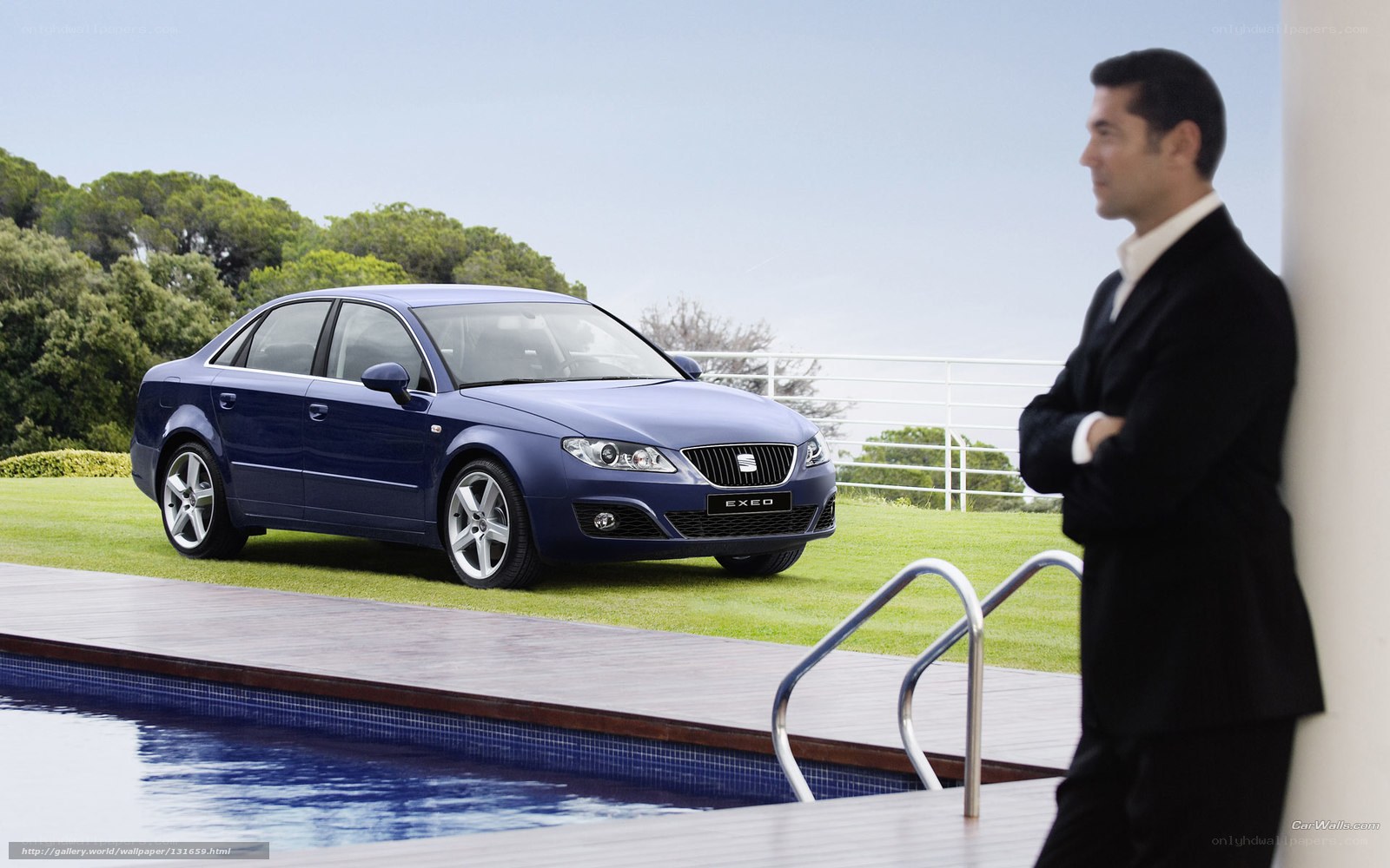 Man with blue sedan by pool