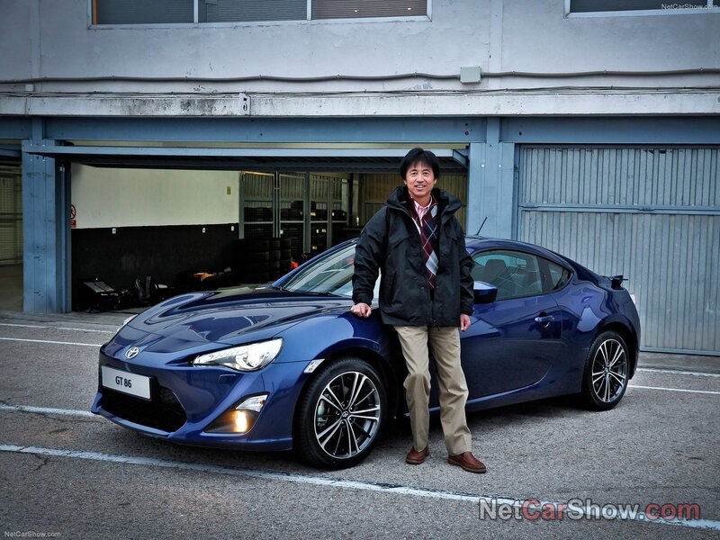 Man with blue sports car