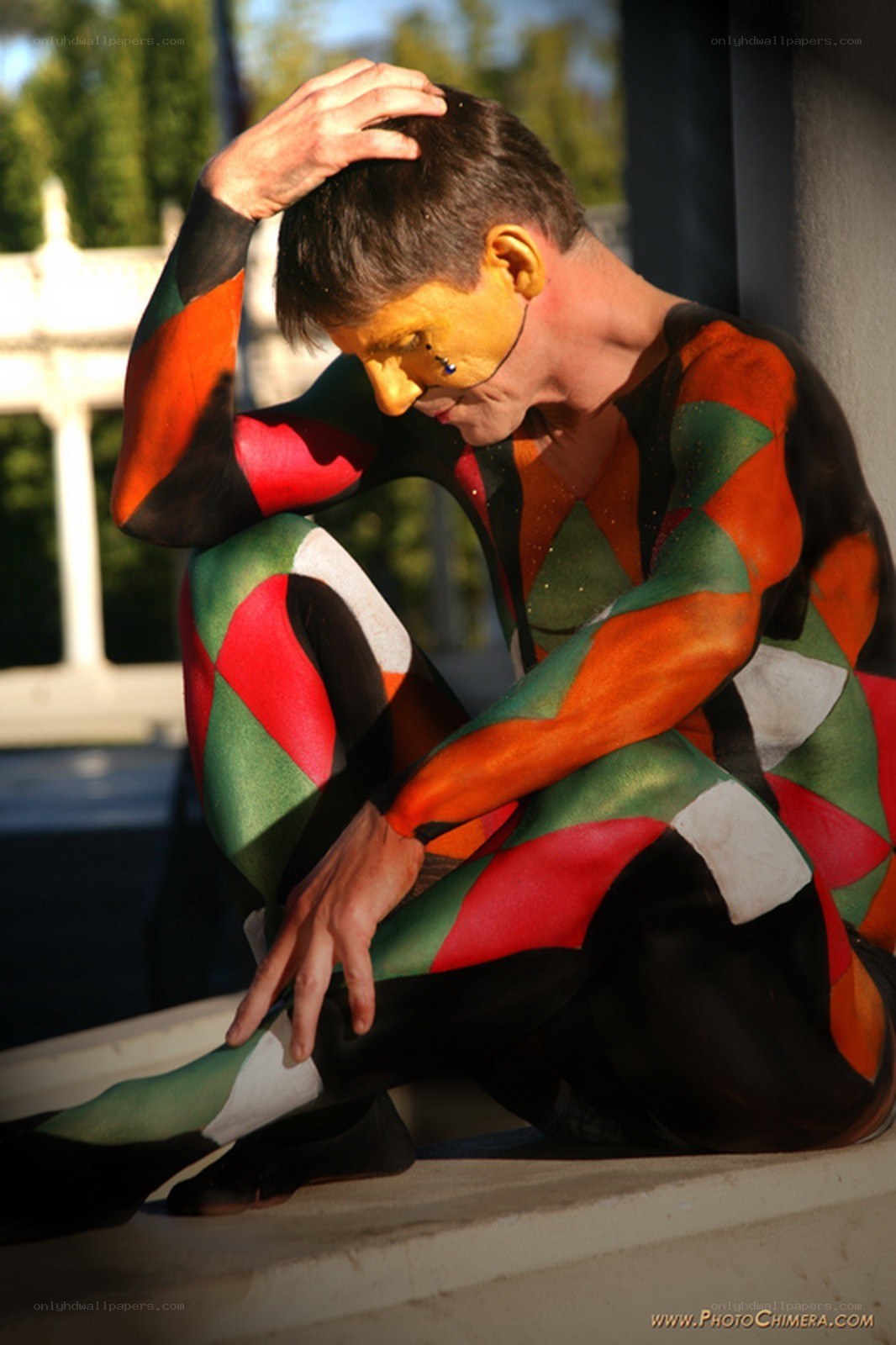 man with body paint sitting