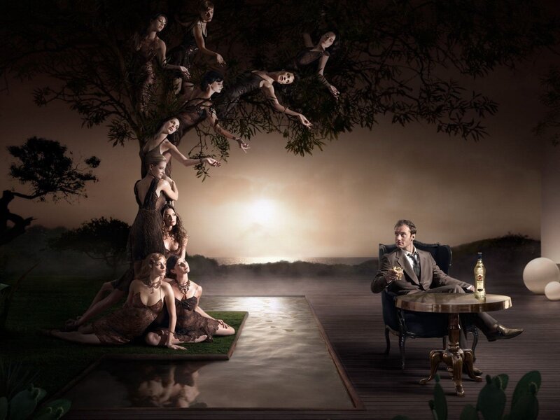 Man with bottle and women in tree