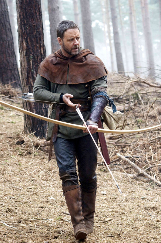 Man with bow in forest