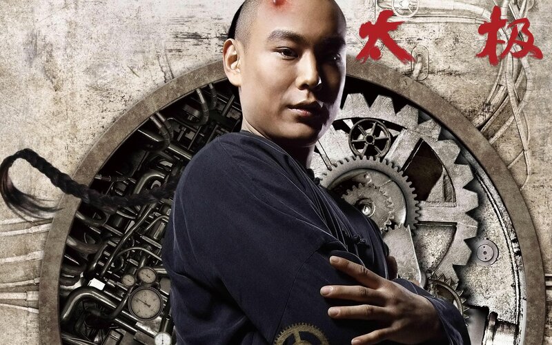 Man with braided hair in front of gears