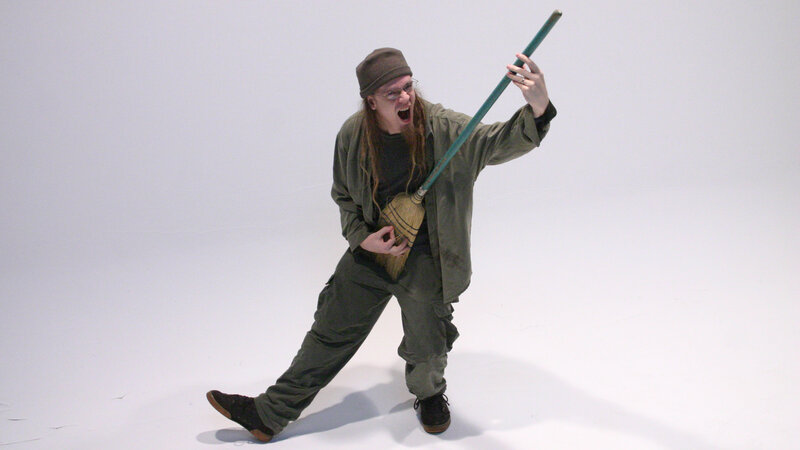 Man with broom in studio