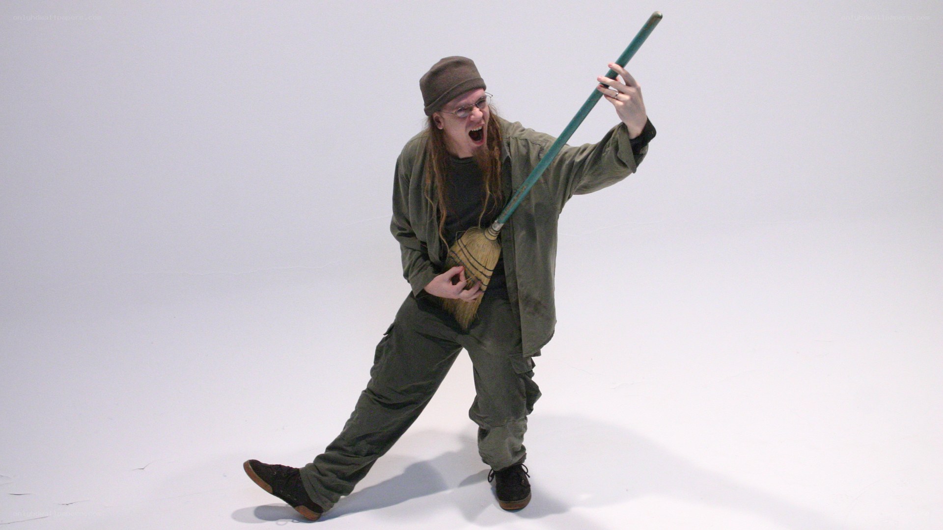 Man with broom in studio