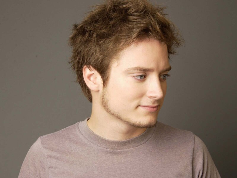 man with brown hair in gray shirt