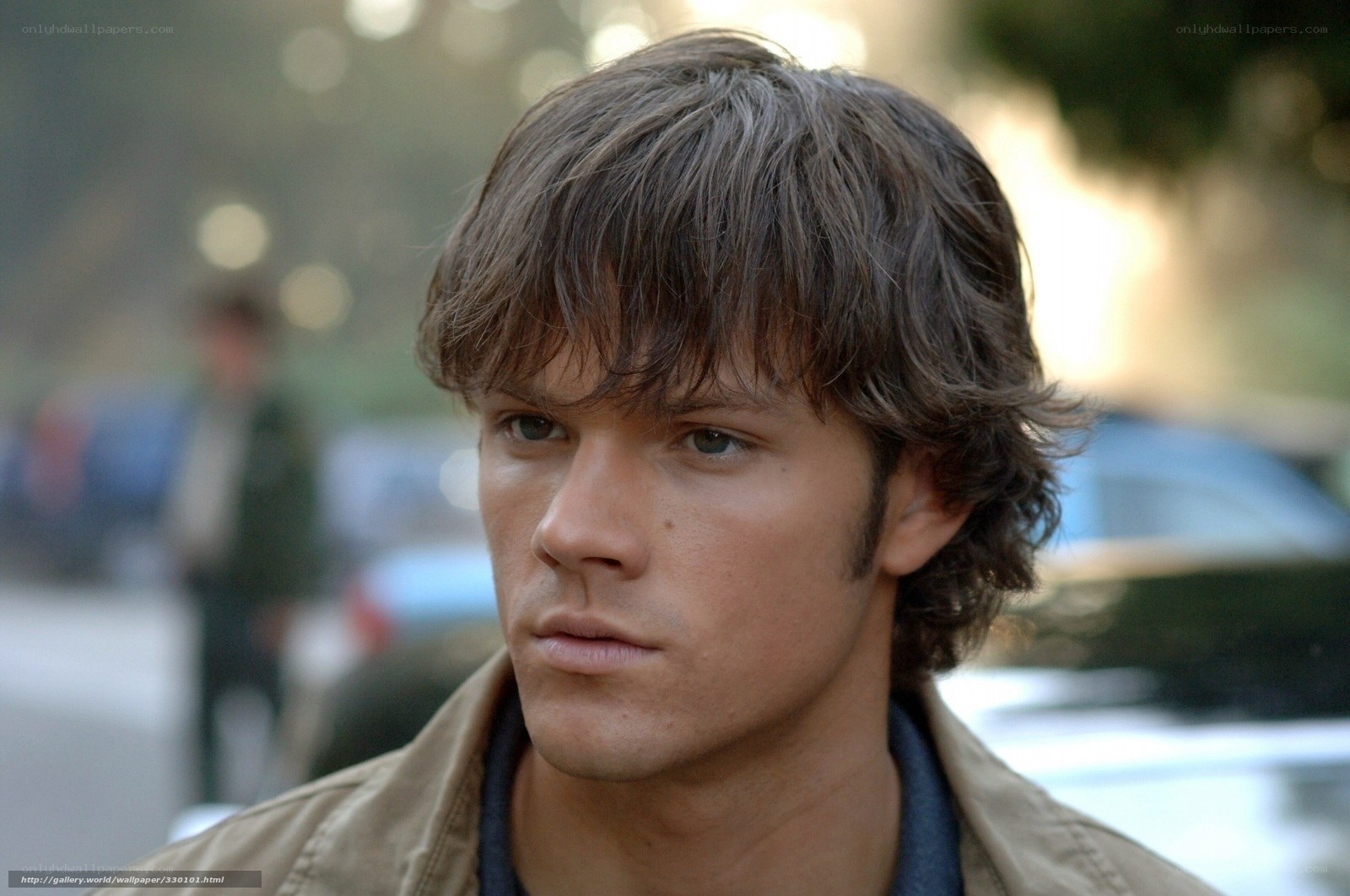 man with brown hair looking away