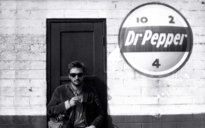 Man with camera by Dr Pepper sign