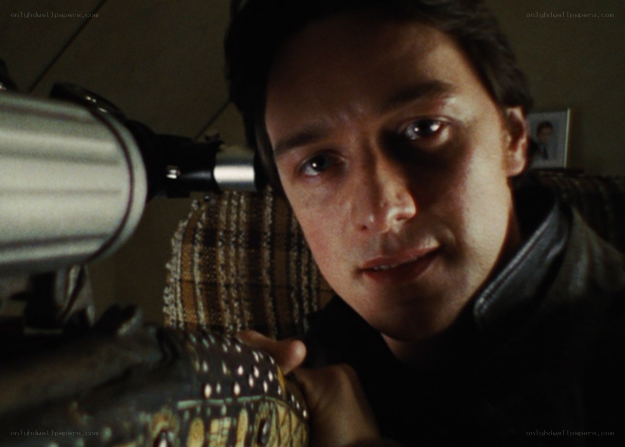 man with camera in dim room