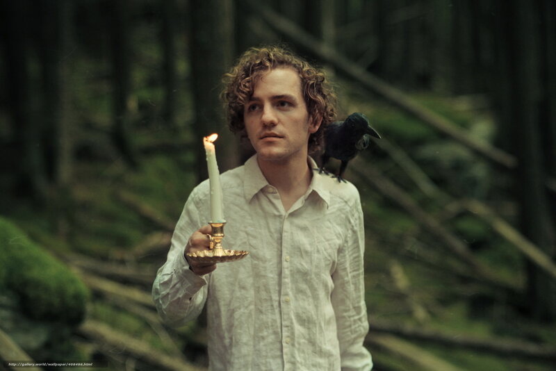 Man with candle in forest