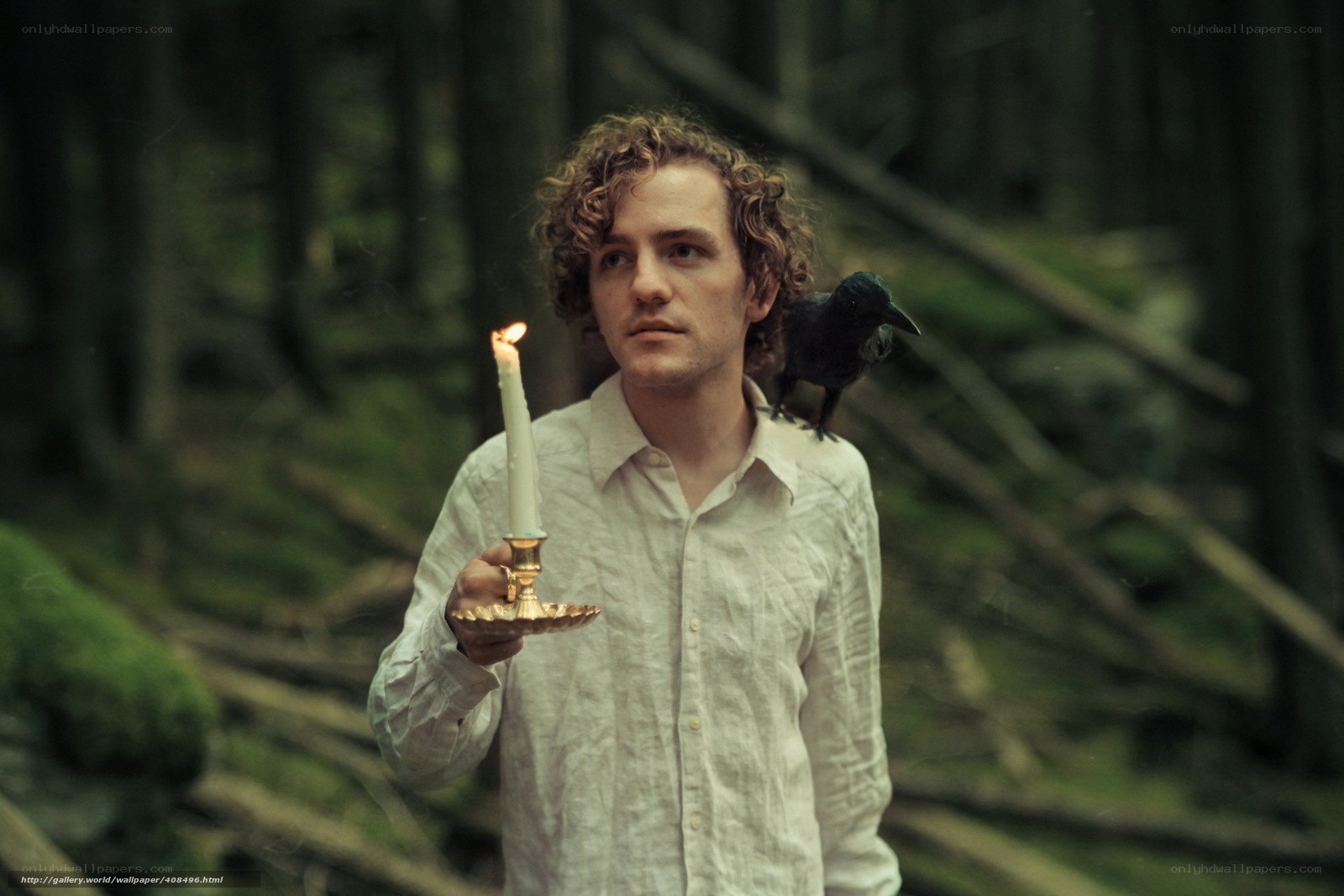 Man with candle in forest