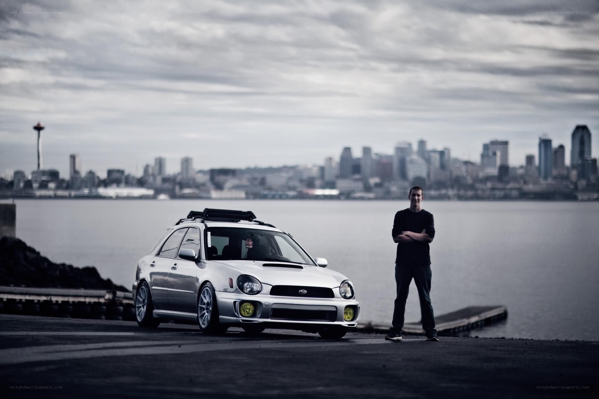Man with car by waterfront