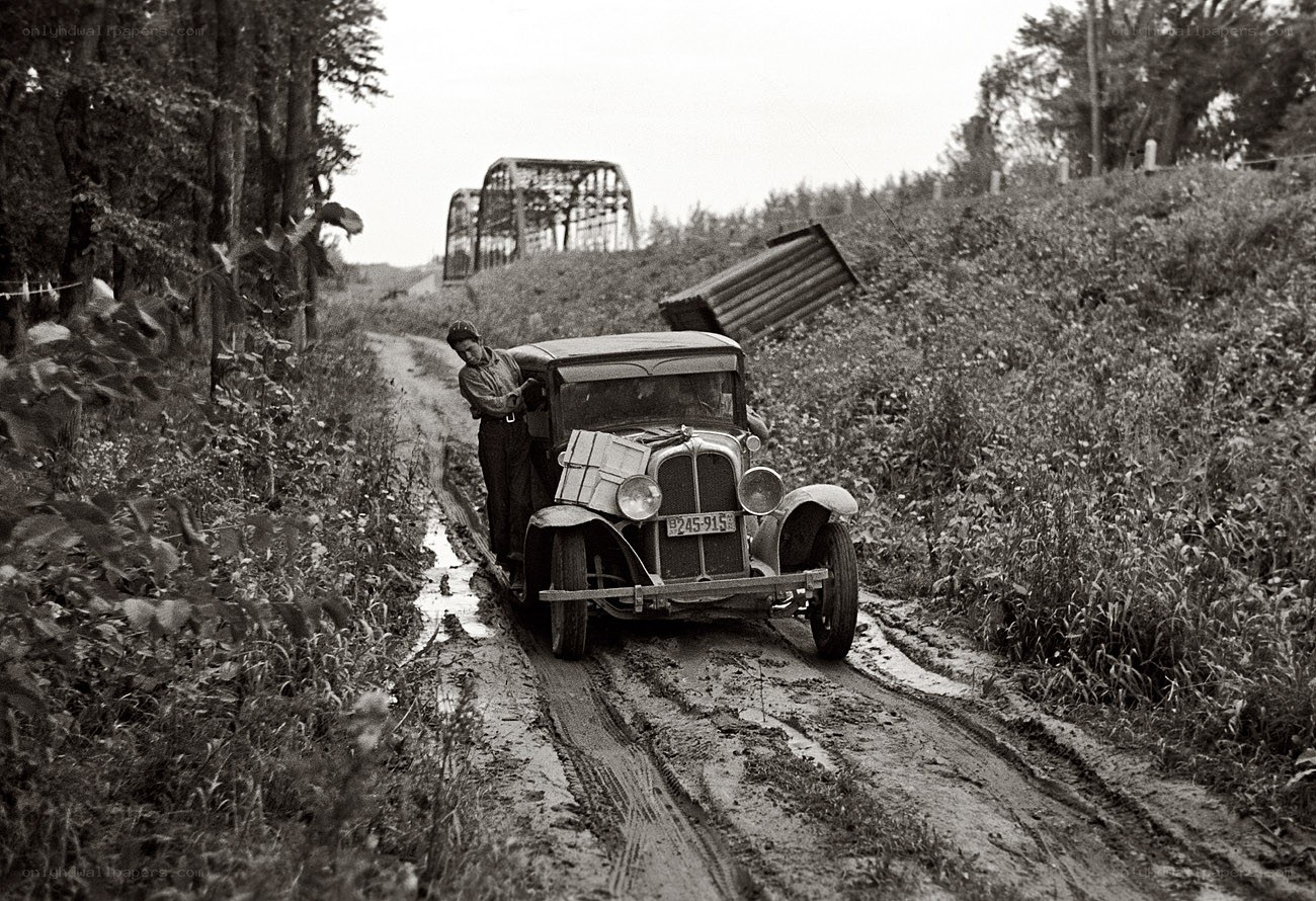Man with car on muddy road
