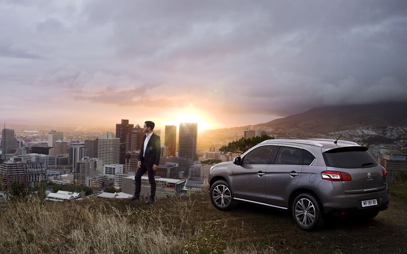 Man with car overlooking city