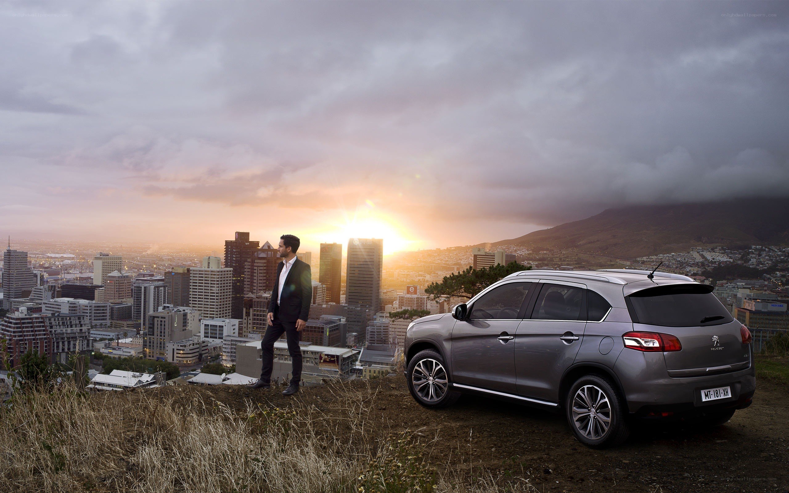 Man with car overlooking city