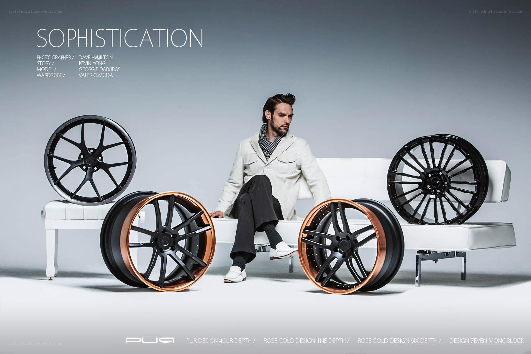 Man with car wheels on sofa