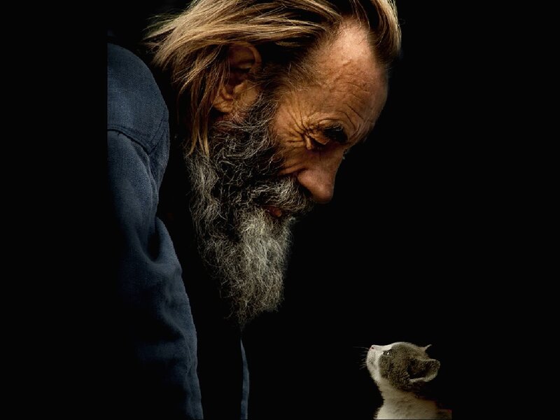 man with cat on black background