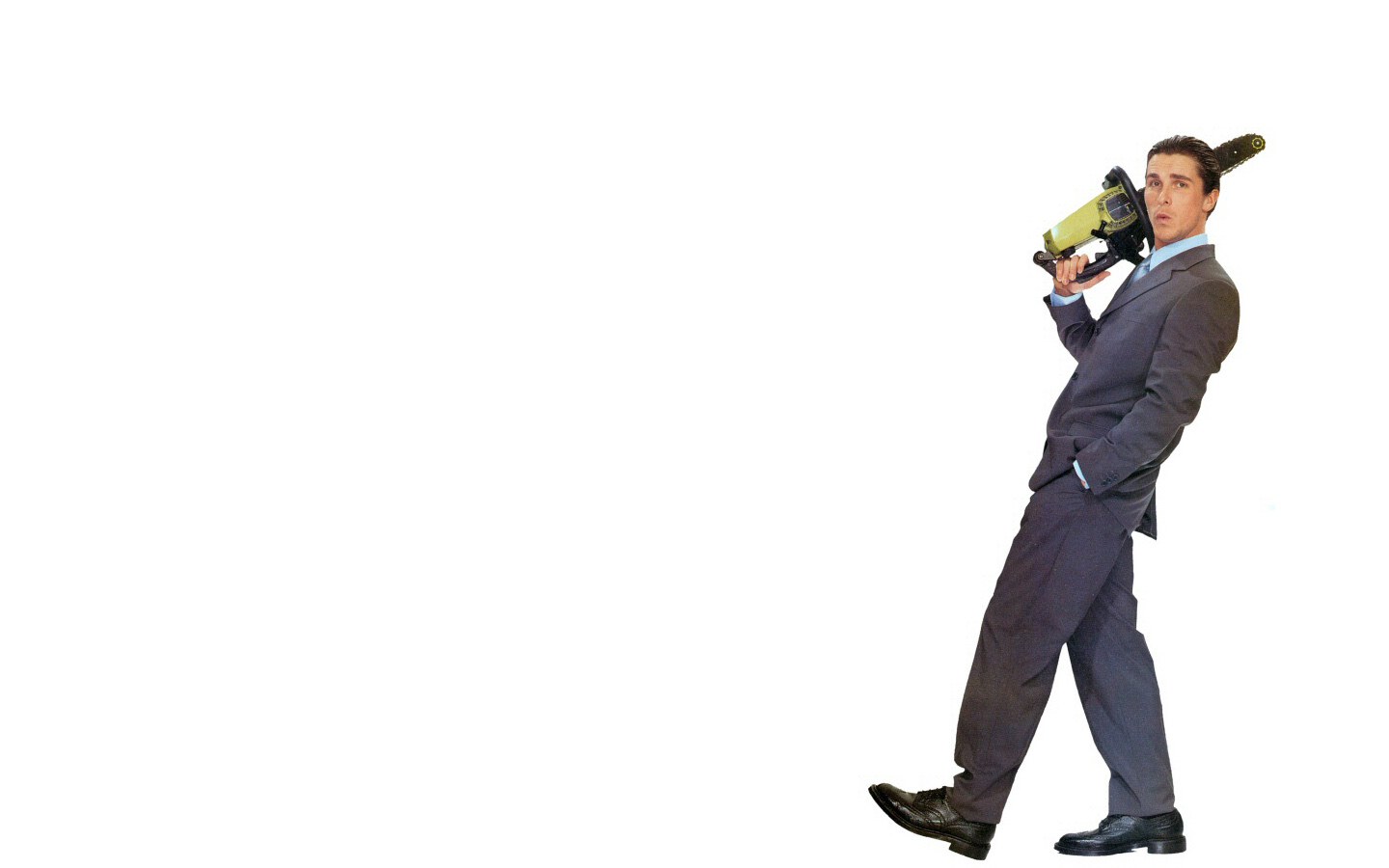 man with chainsaw in suit