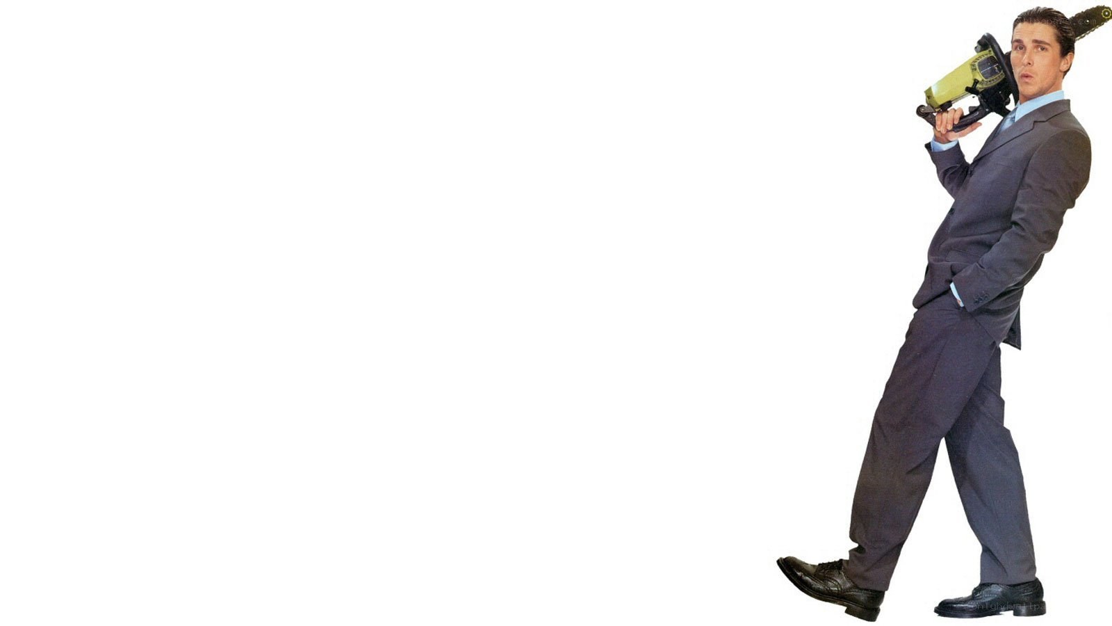man with chainsaw in suit
