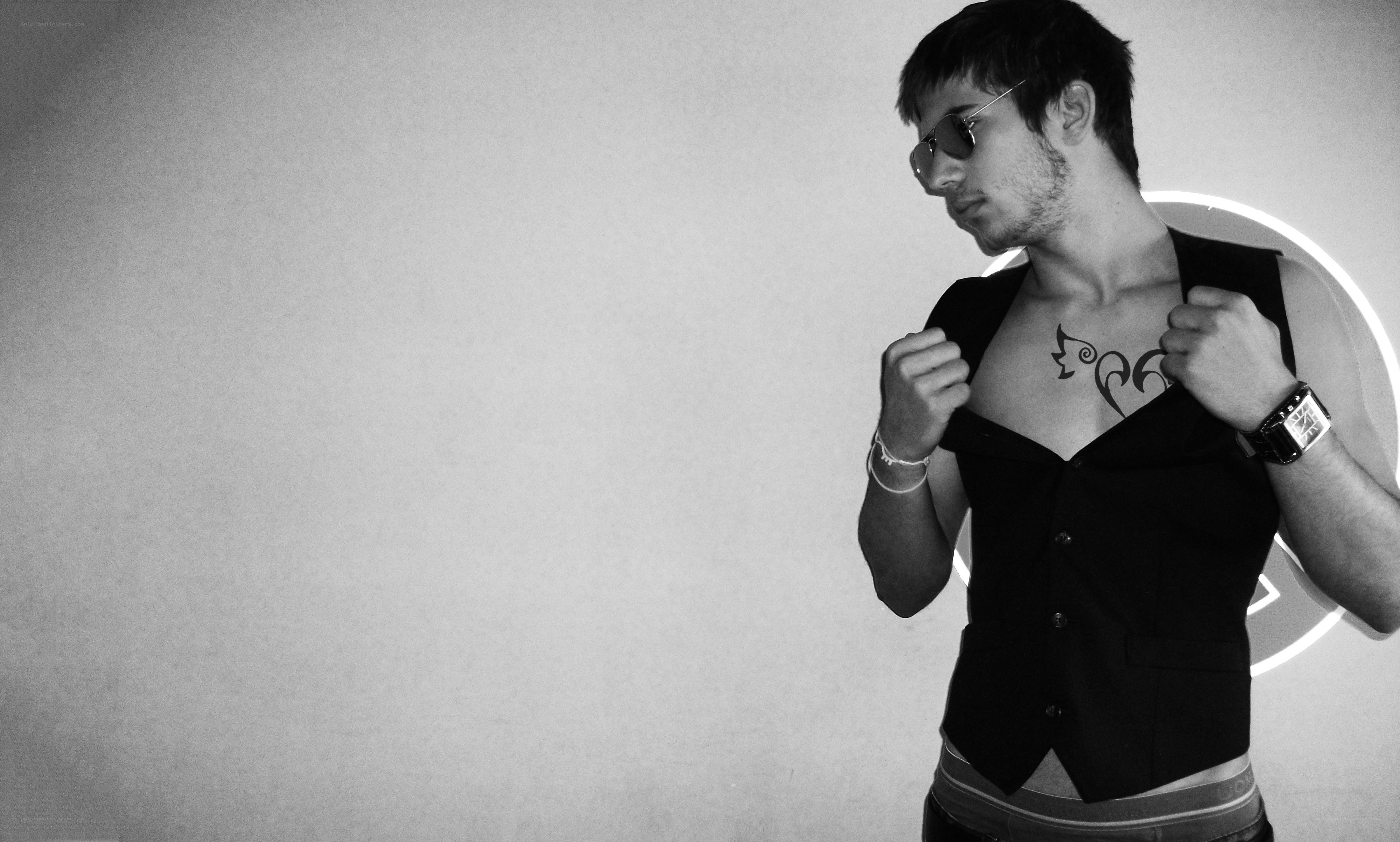 man with chest tattoo and sunglasses