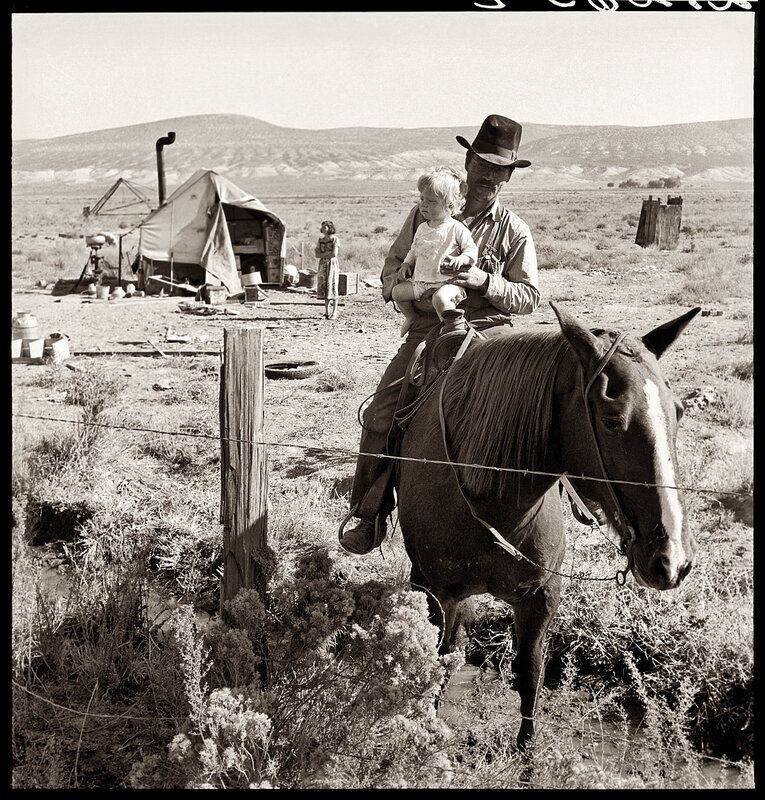 Man with child on horse in desert
