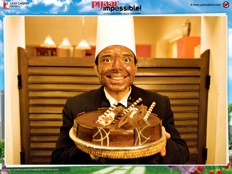 man with chocolate face holding cake