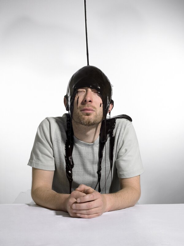 Man with chocolate pouring on head