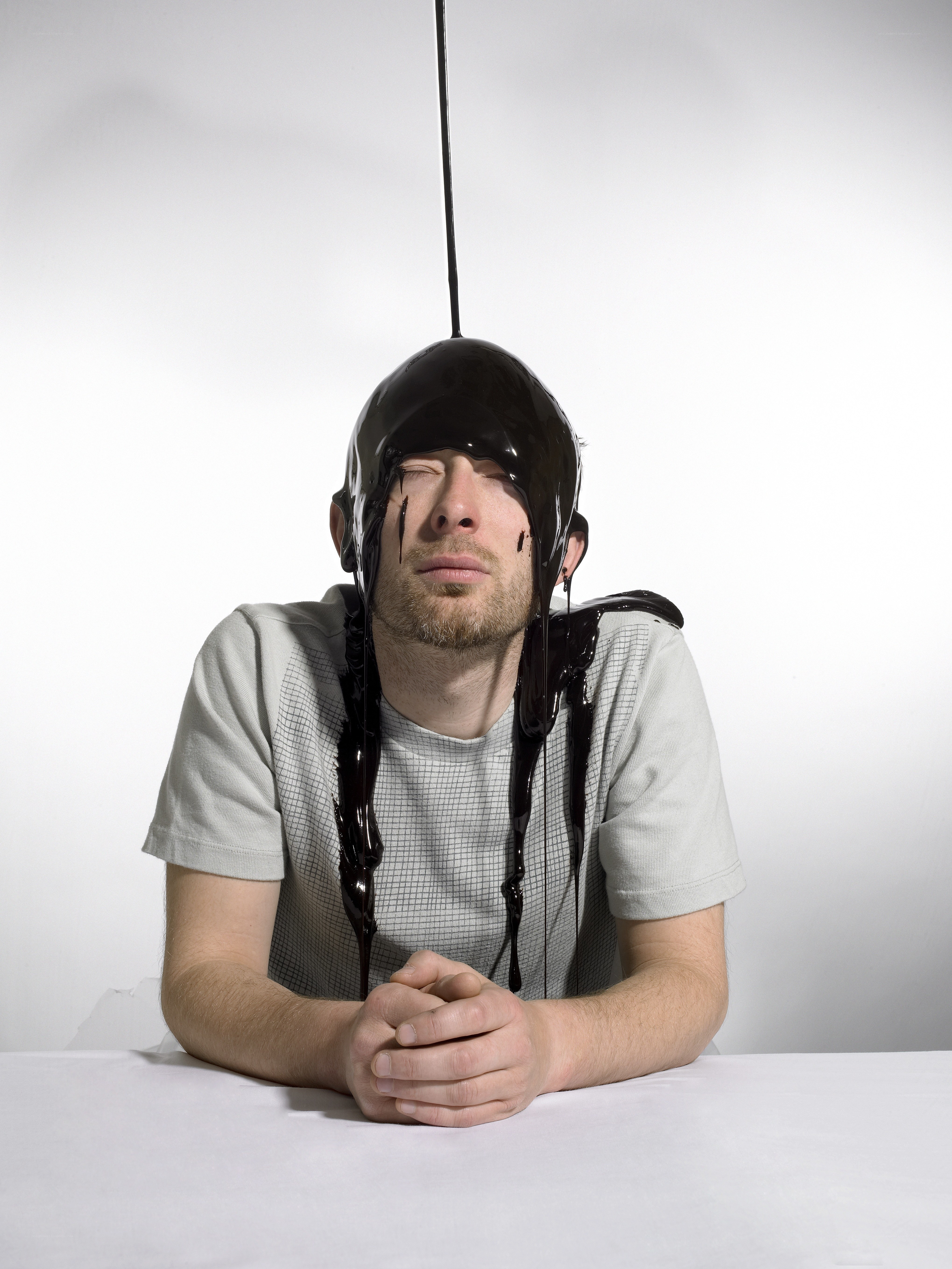 Man with chocolate pouring on head