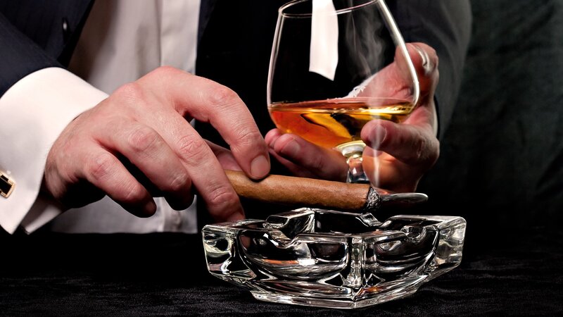man with cigar and whiskey